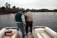 Twice every year; in the spring the channel markers are placed then they are taken out for the winter. Here are Cal Weck and Dan Carlson hauling in a marker - Click to enlarge. Twice every year; in the spring the channel markers are placed then they are taken out for the winter. Here are Cal Weck and Dan Carlson hauling in a marker - Click to enlarge.